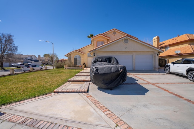 view of front of property with stucco siding, a garage, concrete driveway, and a front yard