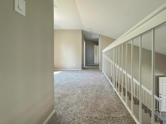 corridor featuring carpet and lofted ceiling