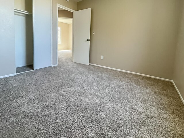 unfurnished bedroom featuring a closet and carpet