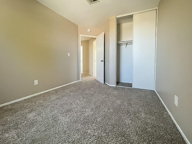 unfurnished bedroom featuring carpet floors and a closet