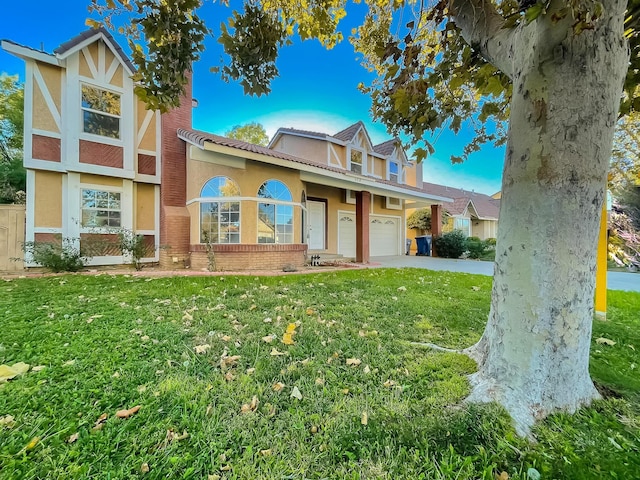 view of front of house with a garage and a front lawn