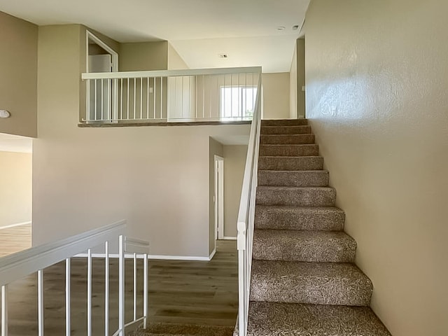 staircase with wood-type flooring