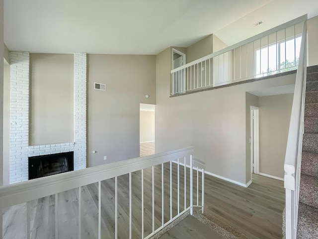 interior space with hardwood / wood-style floors and a towering ceiling