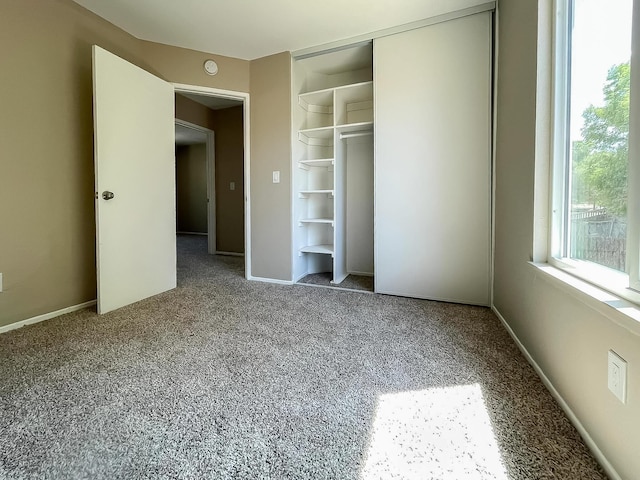 unfurnished bedroom with carpet and a closet