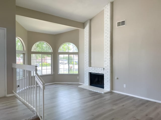 unfurnished living room featuring a fireplace and light wood-type flooring