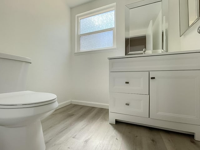 bathroom featuring hardwood / wood-style flooring, vanity, and toilet