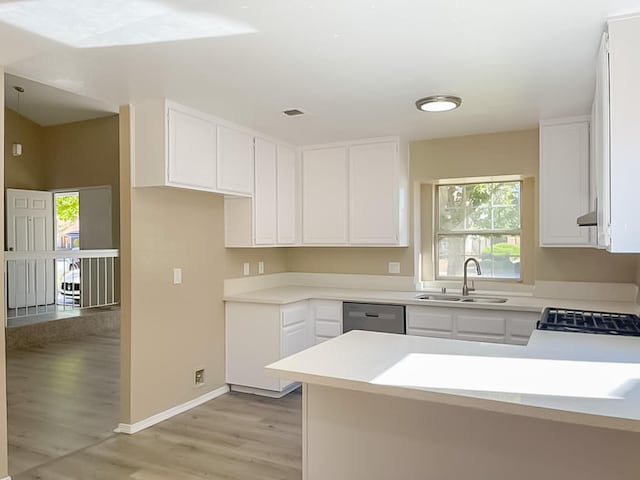 kitchen featuring white cabinetry, sink, light hardwood / wood-style flooring, stainless steel dishwasher, and stove