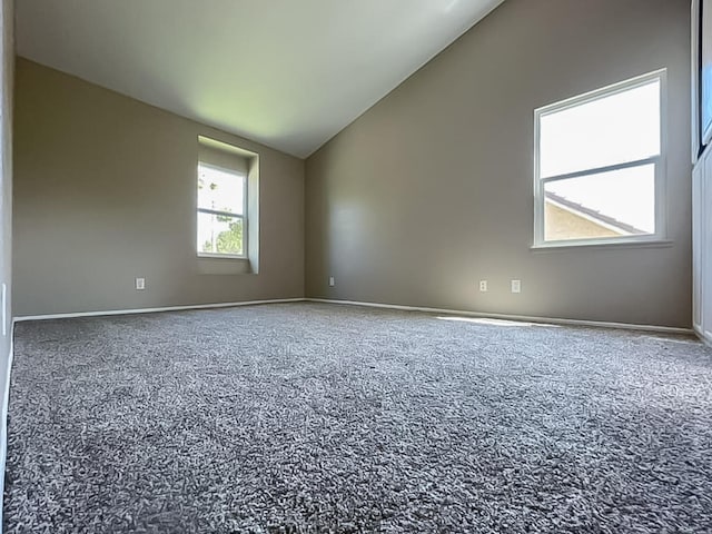 empty room with carpet and vaulted ceiling