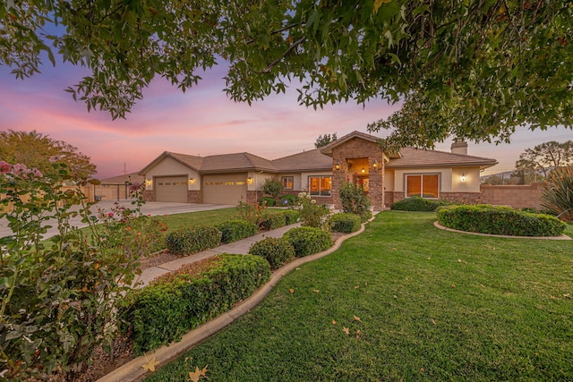 view of front of property featuring a garage and a yard