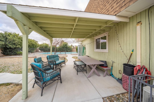 view of patio / terrace featuring an outdoor living space, a fenced in pool, and fence