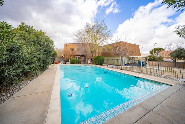 view of swimming pool featuring a fenced in pool, a patio, and fence