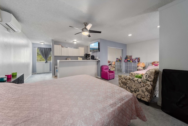 carpeted bedroom featuring ceiling fan, recessed lighting, a wall mounted air conditioner, and a textured ceiling