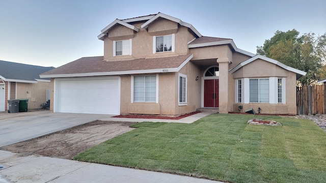 view of front of home with a garage and a front lawn