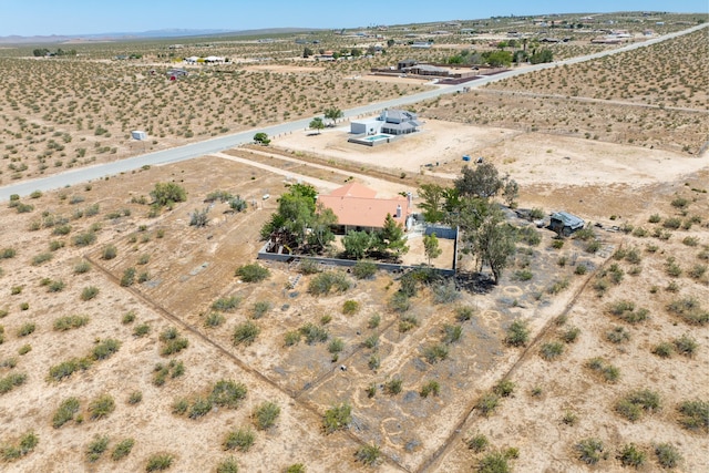 drone / aerial view featuring a desert view and a rural view