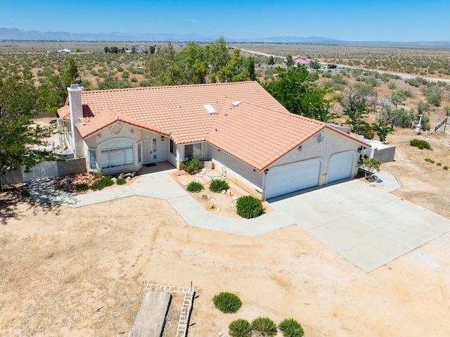 aerial view featuring a desert view and a mountain view