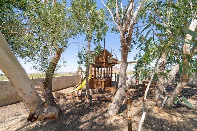 view of jungle gym featuring fence