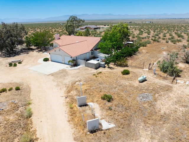 aerial view featuring a desert view and a mountain view