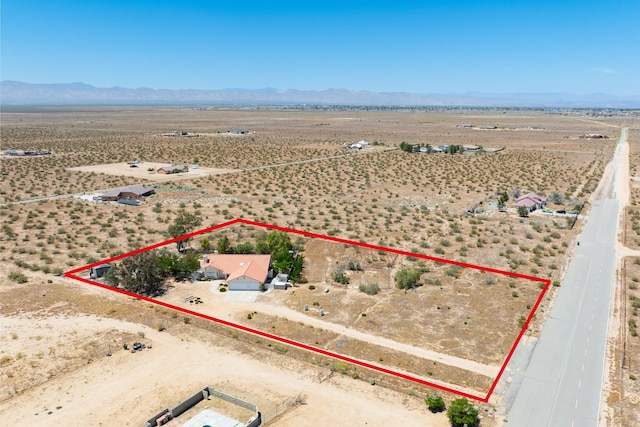 birds eye view of property featuring view of desert, a rural view, and a mountain view