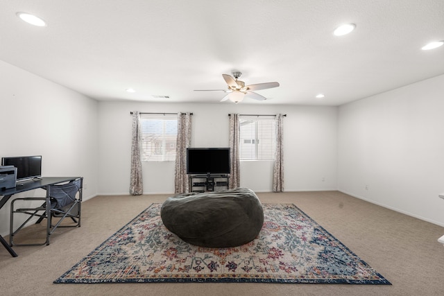 interior space with light colored carpet and ceiling fan