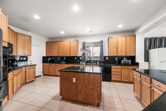 kitchen featuring decorative backsplash, black appliances, a center island, and light tile patterned flooring