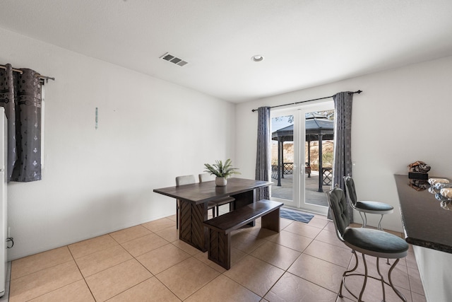 dining space featuring light tile patterned floors