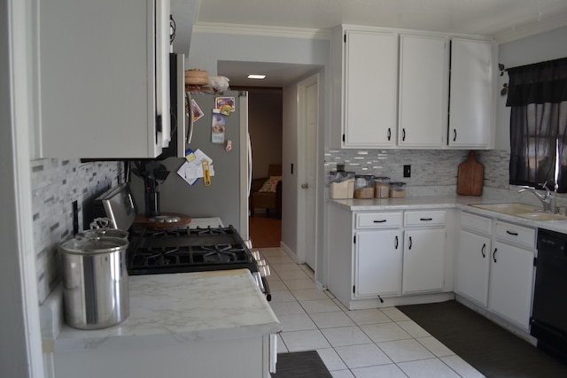 kitchen featuring white cabinets, sink, decorative backsplash, stainless steel fridge, and black dishwasher