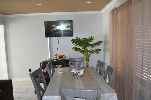 dining room with light tile patterned floors and ornamental molding