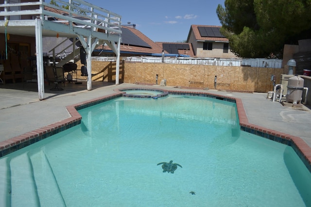 view of swimming pool with an in ground hot tub and a patio