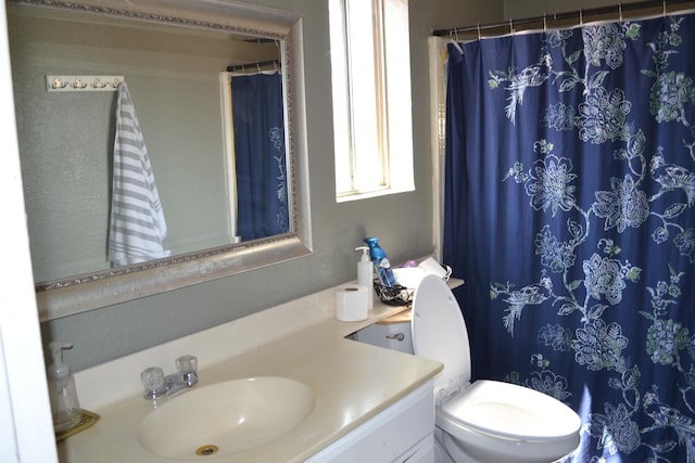 bathroom with vanity and toilet