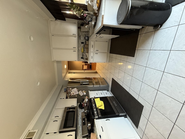 kitchen with backsplash and white cabinetry