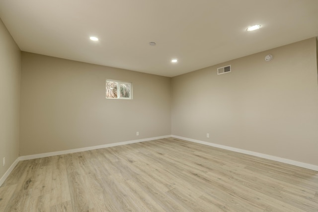 empty room with recessed lighting, baseboards, visible vents, and light wood finished floors