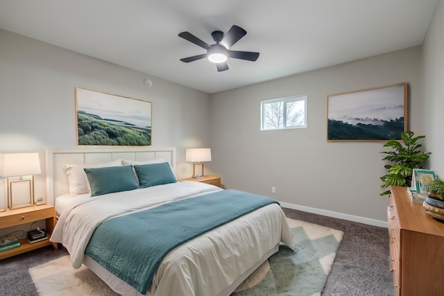 bedroom with dark colored carpet, a ceiling fan, and baseboards