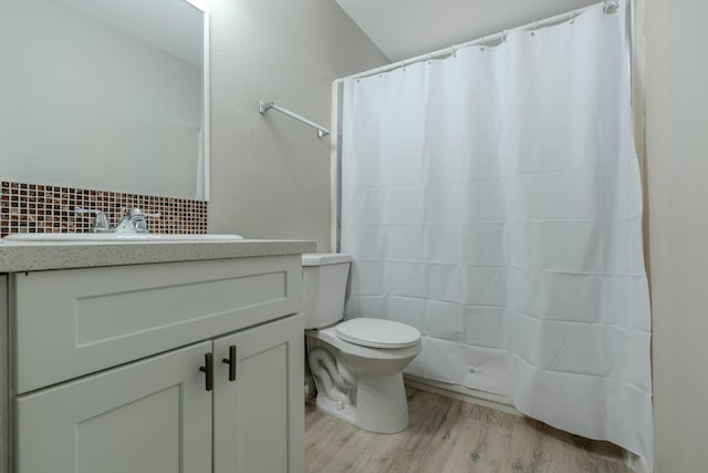 full bath featuring curtained shower, vanity, toilet, and wood finished floors