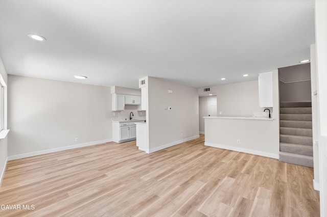 43441 W 30th St Unit 3, Lancaster, CA 93536 - unfurnished living room featuring recessed lighting, light wood-style floors, and stairway