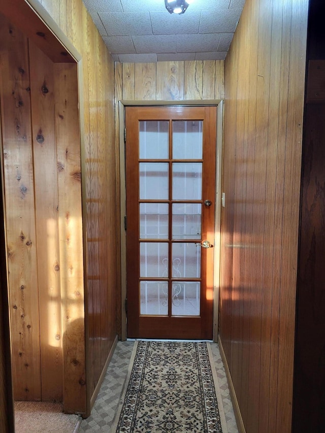 doorway with wooden walls