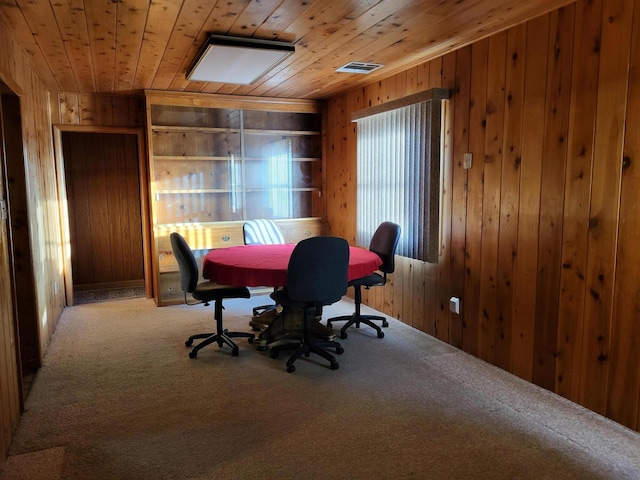 carpeted office space featuring wooden ceiling and wood walls