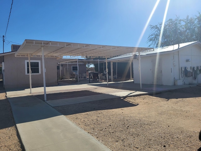 rear view of property featuring a carport