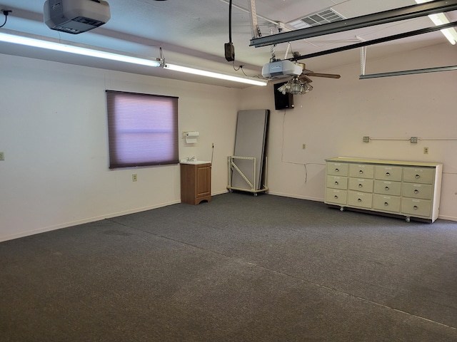 garage featuring a garage door opener and ceiling fan