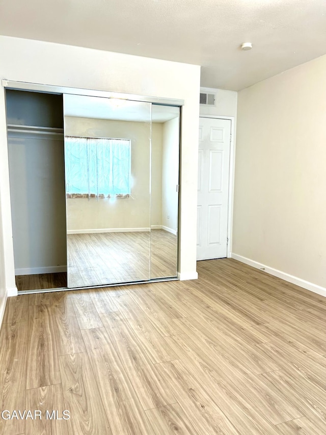 38710 E 10th St Unit 12, Palmdale, CA 93550 - unfurnished bedroom featuring wood finished floors and baseboards
