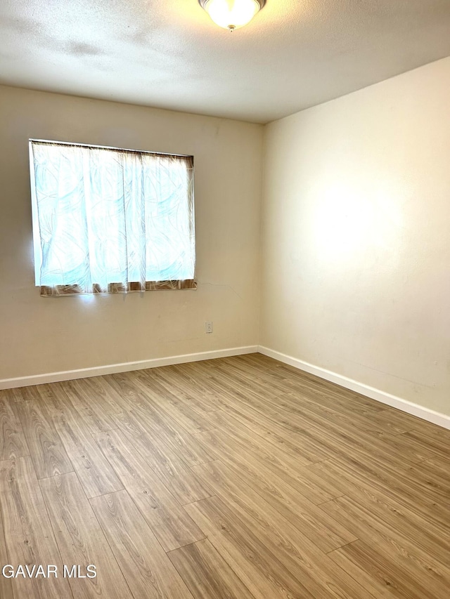 38710 E 10th St Unit 12, Palmdale, CA 93550 - unfurnished room with wood finished floors and a textured ceiling