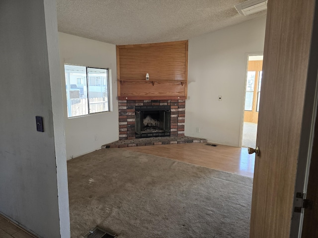 unfurnished living room with a textured ceiling, light colored carpet, a brick fireplace, and lofted ceiling