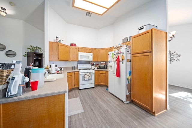 2908 Owens Way, Rosamond, CA 93560 - kitchen with white appliances, light wood-style flooring, light countertops, and high vaulted ceiling