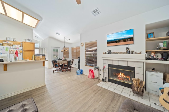 2908 Owens Way, Rosamond, CA 93560 - living area featuring lofted ceiling, a tiled fireplace, wood finished floors, and baseboards