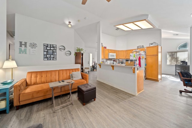 2908 Owens Way, Rosamond, CA 93560 - living room featuring light wood-style floors, high vaulted ceiling, ceiling fan, and baseboards
