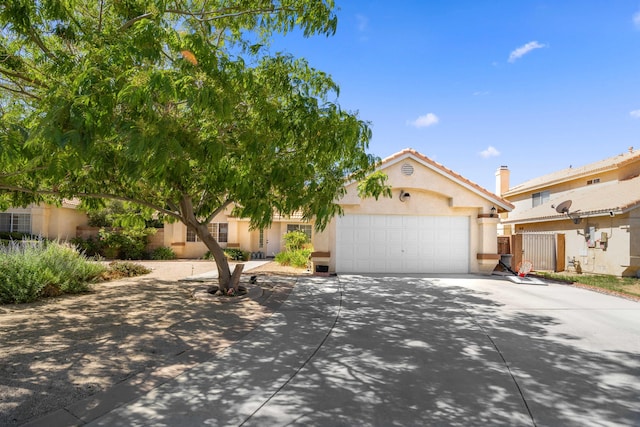 2908 Owens Way, Rosamond, CA 93560 - view of front of house featuring a garage, stucco siding, driveway, and a tiled roof