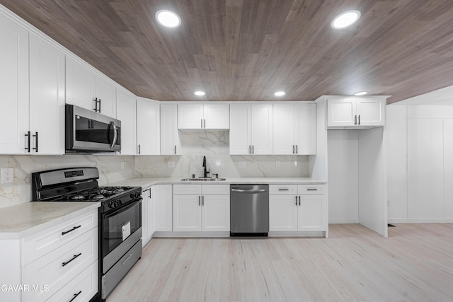 2465 W 55th St, Rosamond, CA 93560 - kitchen with stainless steel appliances, wooden ceiling, light stone countertops, white cabinets, and tasteful backsplash