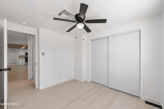 2465 W 55th St, Rosamond, CA 93560 - unfurnished bedroom with light wood finished floors, a closet, and ceiling fan
