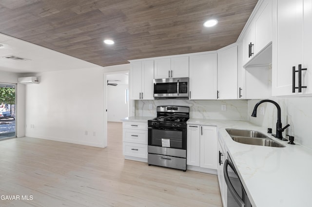 2465 W 55th St, Rosamond, CA 93560 - kitchen with appliances with stainless steel finishes, an AC wall unit, light stone countertops, wood ceiling, and white cabinetry