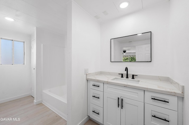 2465 W 55th St, Rosamond, CA 93560 - bathroom featuring vanity, wood finished floors, recessed lighting, and bathing tub / shower combination