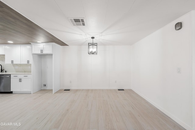 2465 W 55th St, Rosamond, CA 93560 - unfurnished dining area with light wood-type flooring, recessed lighting, and a chandelier